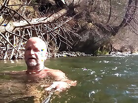 naked uncut bear chilling in the river