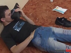 Joyous dude sniffing shoe while tugging